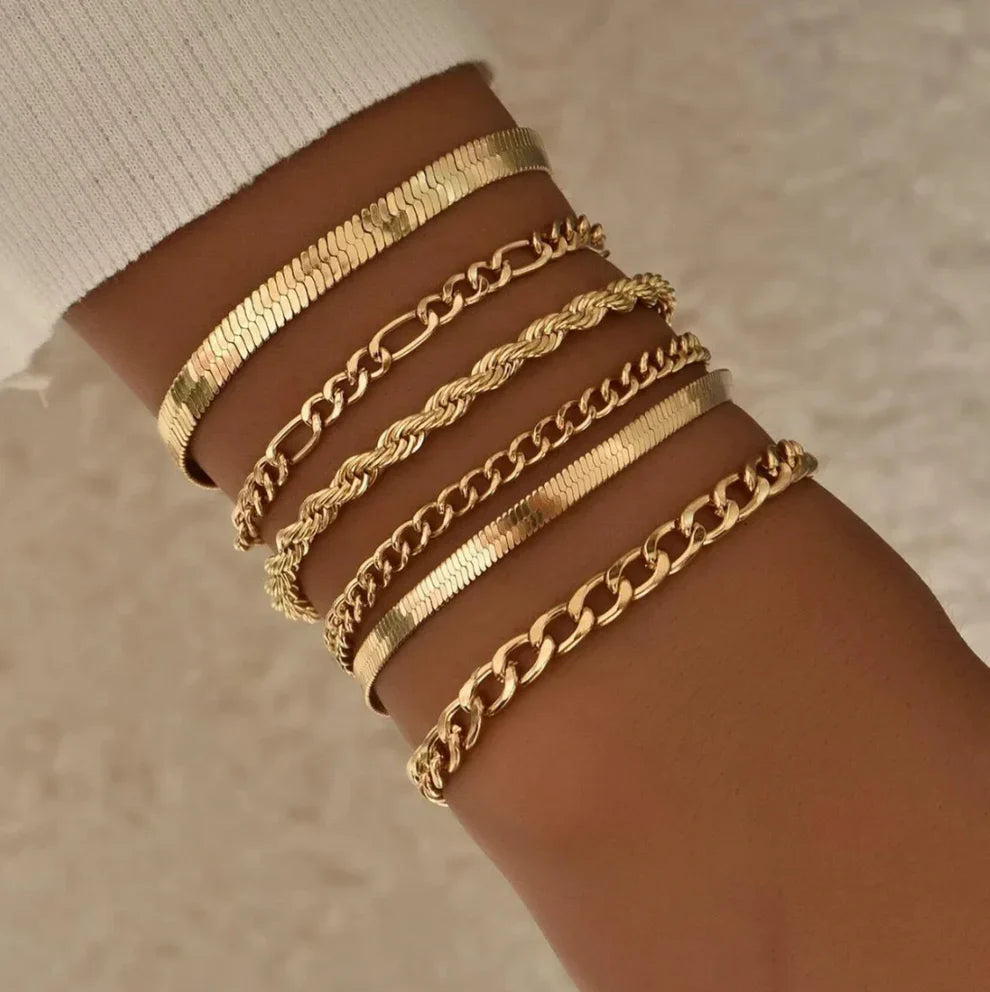 Set of gold bracelets with different chain styles